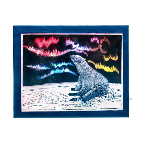 Multimedia light box with seated polar bear looking at the aurora linocut printed on Japanese kozo (or mulberry) paper with some electronics to make a mesmerizing  arctic scene with colour changing Northern Lights. 

Powered with a stardard 9V battery an array of self-flashing RGB LEDs provide an ever-changing pattern of light and colour. There’s a narrow white margin, a blue frame with visible silver switch, shot on a white background.