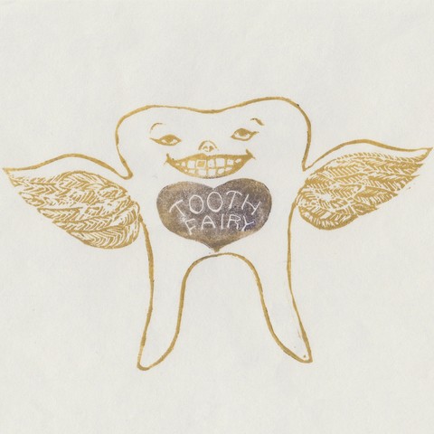My linocut tooth fairy is shaped like a tooth with two roots instead of legs and little bird-like wings and a small grinning face, printed in gold ink on white Japanese paper. It appears to have one gold filling int its own teeth. There’s a purple heart below its face with “TOOTH FAIRY” carved into it.
