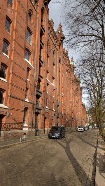 Old brick warehouses. A road. Trees.